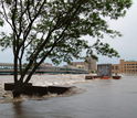 waters spilled out of riverbanks into the street in a city